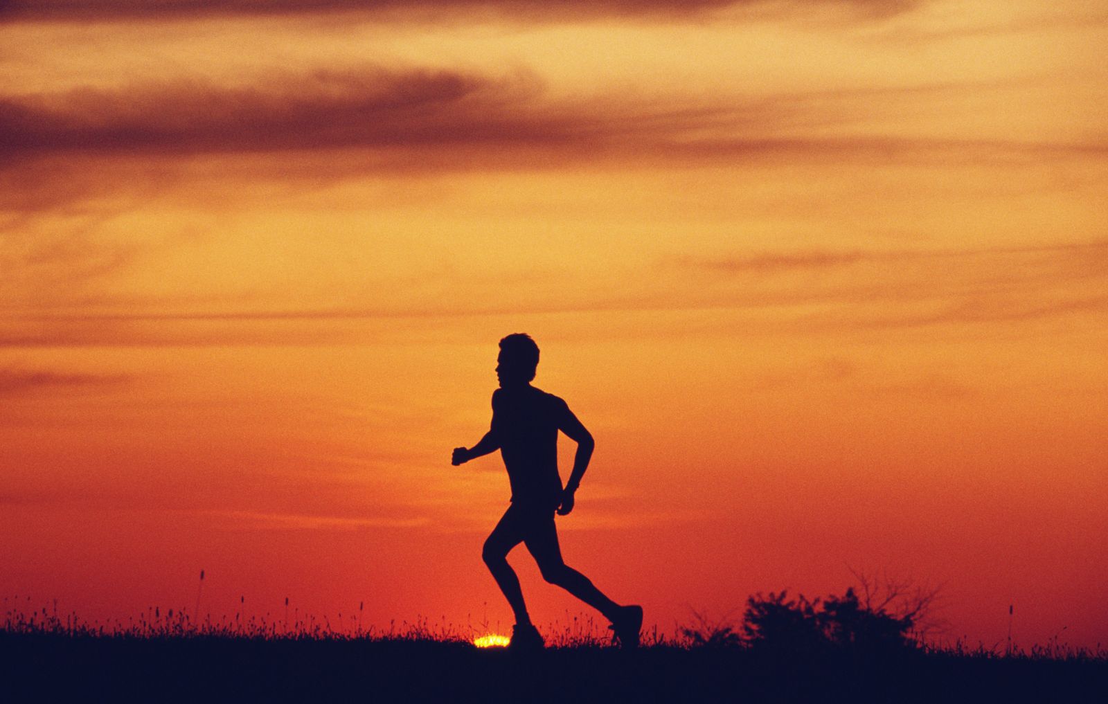 Person running in front of sunset